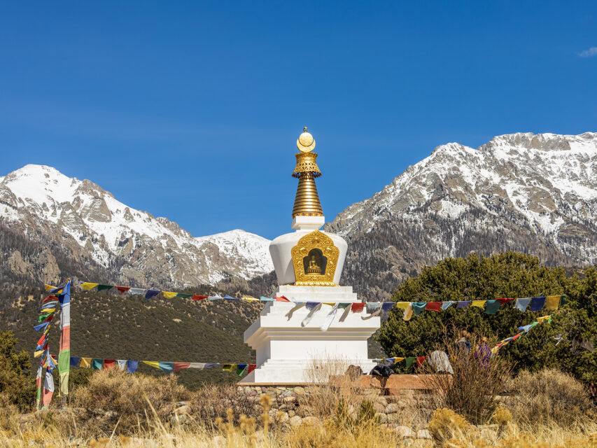 Buddhist stupa with prayer flags and Sangre de Cristo mountains in Crestone, Colorado